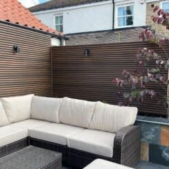 Piranha Shadow Gap Cladding Board - All Colours -Build4less Shop Piranha Shadow Gap Brown Cedar Cladding Board Garden Boundary behind Corner Sofa abc815af aef7 4870 bf6c bd9d14ce2a55